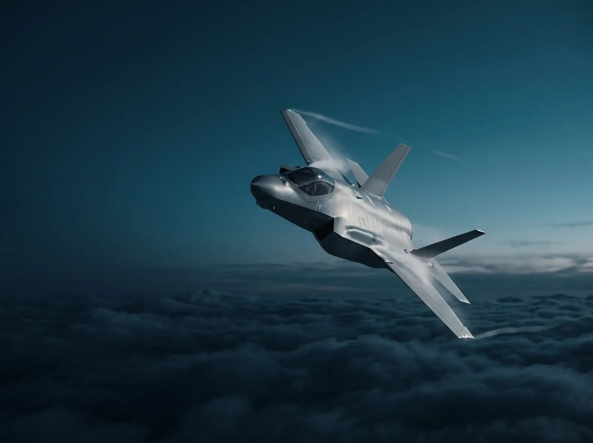 Fighter-class aircraft banking above clouds at dusk